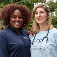 Two nursing students smiling together outside.